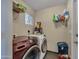 Laundry room featuring front load washer and dryer, storage, sink and tile floors at 18035 N 29Th Dr, Phoenix, AZ 85053