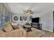 Cozy living room with a plush sofa, patterned rug, and a modern entertainment center with a fireplace at 18035 N 29Th Dr, Phoenix, AZ 85053
