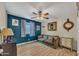 Comfortable living room with wood floors, accent wall and vintage-style sofa at 18035 N 29Th Dr, Phoenix, AZ 85053