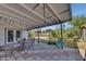 Charming covered patio with tile flooring and colorful string lights overhead, perfect for outdoor entertaining at 18035 N 29Th Dr, Phoenix, AZ 85053