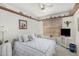 Cozy bedroom featuring a plush bed, charming decor and shelving, and a window with natural light at 19546 N 53Rd Ave, Glendale, AZ 85308