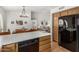 Modern kitchen with stainless steel appliances and breakfast bar, seamlessly flowing into adjacent dining and living areas at 19546 N 53Rd Ave, Glendale, AZ 85308