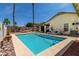 Backyard pool area with palm trees, lounge chairs, and privacy fencing at 19546 N 53Rd Ave, Glendale, AZ 85308