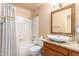 Bathroom featuring a shower-tub combo with sink with granite countertops and wood cabinets at 1956 E Calle De Caballos --, Tempe, AZ 85284