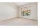 Bright bedroom with a pool view, large window, neutral carpet, and vaulted ceiling at 1956 E Calle De Caballos --, Tempe, AZ 85284