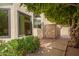 Home exterior showcases an open side yard with a decorative window, side gate and desert landscaping at 1956 E Calle De Caballos --, Tempe, AZ 85284