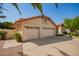 Spacious three-car garage, concrete driveway, desert landscaping, and tile roof at 1956 E Calle De Caballos --, Tempe, AZ 85284