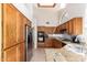 Spacious kitchen with stainless steel appliances, granite countertops, and oak cabinets at 1956 E Calle De Caballos --, Tempe, AZ 85284