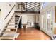 Open living space featuring hardwood floors, an office, and a metal staircase to the upper floors at 1956 E Calle De Caballos --, Tempe, AZ 85284