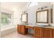 Main bathroom features double sink vanities, granite countertop and a bathtub underneath a window at 1956 E Calle De Caballos --, Tempe, AZ 85284