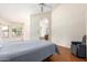 Large main bedroom with ensuite bathroom, wood flooring, recliner and multiple windows at 1956 E Calle De Caballos --, Tempe, AZ 85284