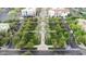 Aerial view of a meticulously landscaped community park with palm trees, walking paths, and manicured lawns at 20545 W Terrace Ln, Buckeye, AZ 85396