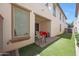 Backyard featuring an outdoor patio, artificial turf, seating area, and block wall fence for privacy at 20545 W Terrace Ln, Buckeye, AZ 85396