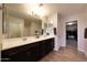 Bathroom featuring double sinks, a large mirror, and tile floors at 20545 W Terrace Ln, Buckeye, AZ 85396