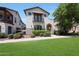 Charming home with manicured lawn, lush green shrubbery, awning, and traditional architectural details at 20545 W Terrace Ln, Buckeye, AZ 85396