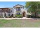 Charming two-story home featuring a well-manicured front yard and a welcoming entrance with an arched doorway at 20545 W Terrace Ln, Buckeye, AZ 85396