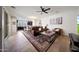 Inviting living room showcasing tile floors, stylish furniture, and an open layout connected to the kitchen at 20545 W Terrace Ln, Buckeye, AZ 85396