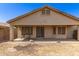Exterior view of covered patio, sliding glass door, and lawn at 20895 E Via Del Rancho Rd, Queen Creek, AZ 85142
