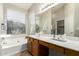 Bright bathroom features double windows, soaking tub and large vanity at 20895 E Via Del Rancho Rd, Queen Creek, AZ 85142