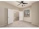 Carpeted bedroom featuring a ceiling fan, window, and doorway at 20895 E Via Del Rancho Rd, Queen Creek, AZ 85142