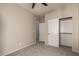 Well-lit bedroom boasts neutral colors, carpet, and a closet at 20895 E Via Del Rancho Rd, Queen Creek, AZ 85142