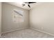 Empty bedroom with ceiling fan and window at 20895 E Via Del Rancho Rd, Queen Creek, AZ 85142