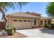Beige home featuring a two-car garage, tile roof, and desert landscaping at 20895 E Via Del Rancho Rd, Queen Creek, AZ 85142
