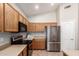 Well-lit kitchen features stainless steel appliances and ample cabinet space at 20895 E Via Del Rancho Rd, Queen Creek, AZ 85142