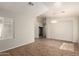 Bright, tiled living room featuring arched doorways, neutral paint, and ample natural light at 20895 E Via Del Rancho Rd, Queen Creek, AZ 85142