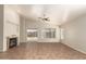 Open living room with tile floors, a fireplace, sliding glass doors, and a ceiling fan at 20895 E Via Del Rancho Rd, Queen Creek, AZ 85142