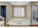 Bathroom features a jacuzzi tub with wood floor, shower and toilet at 211 W Kaler Dr, Phoenix, AZ 85021