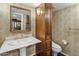 Traditional bathroom features a pedestal sink, built in cabinet and decorative wall coverings at 211 W Kaler Dr, Phoenix, AZ 85021