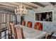 Dining room with a floral wallpaper, chandelier, and a table set for a dinner party at 211 W Kaler Dr, Phoenix, AZ 85021