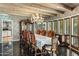 Formal dining room featuring an ornate chandelier, wood beam ceiling, and classic furnishings at 211 W Kaler Dr, Phoenix, AZ 85021