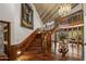 Grand foyer with a high ceiling, hardwood floors, staircase and beautiful chandelier at 211 W Kaler Dr, Phoenix, AZ 85021