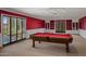 Bright game room with pool table, recessed lighting and built-in bookshelves at 211 W Kaler Dr, Phoenix, AZ 85021