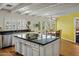 Spacious kitchen with a center island, granite counters, stainless steel appliances, and bright natural light at 211 W Kaler Dr, Phoenix, AZ 85021