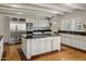 Bright kitchen with white cabinetry, a large island and stainless steel appliances at 211 W Kaler Dr, Phoenix, AZ 85021