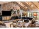 Cozy living area showcasing a stone fireplace, piano, and stylish decor at 211 W Kaler Dr, Phoenix, AZ 85021