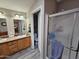 Well-lit bathroom featuring double vanity sinks, a shower, and a separate toilet room at 2121 N Center St # 131, Mesa, AZ 85201