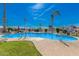 Enjoy the community pool area with lush green grass, palm trees, and lounge seating at 2121 N Center St # 131, Mesa, AZ 85201