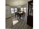 Bright dining room featuring a stylish chandelier, ample natural light, and modern flooring at 2121 N Center St # 131, Mesa, AZ 85201