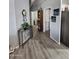 Inviting hallway with lovely artwork, console table and eye-catching clock at 2121 N Center St # 131, Mesa, AZ 85201