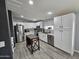 Modern kitchen with white cabinets, stainless steel appliances, and granite countertops, offering a stylish and functional space at 2121 N Center St # 131, Mesa, AZ 85201