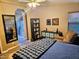 Bedroom featuring a ceiling fan, full length mirror, en suite bathroom, and comfortable chair at 2121 N Center St # 131, Mesa, AZ 85201