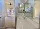 Bathroom with a white sink, vanity, and a glimpse of the bedroom and balcony at 2402 E 5Th St # 1472, Tempe, AZ 85288