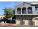 Stylish two-story townhome with a balcony, three garages, and a neutral color palette, adding architectural interest at 2402 E 5Th St # 1472, Tempe, AZ 85288