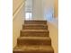 Carpeted staircase leads to the upper level, providing access to bedrooms, bathrooms, and a bright living area at 2402 E 5Th St # 1472, Tempe, AZ 85288