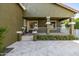 Covered back porch with stone floors, columns, white railing and garden at 2743 E Virginia St, Gilbert, AZ 85296