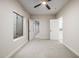Neutral bedroom with a ceiling fan, carpeted floor, and a window providing natural light at 2743 E Virginia St, Gilbert, AZ 85296